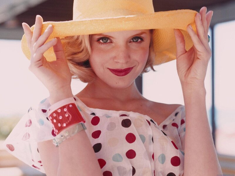 woman in yellow hat smiling