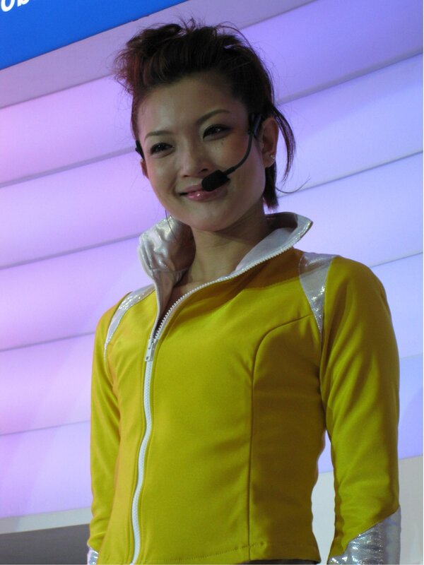 woman in yellow jacket at event