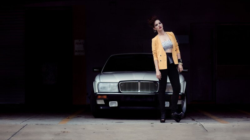 woman in yellow jacket by car