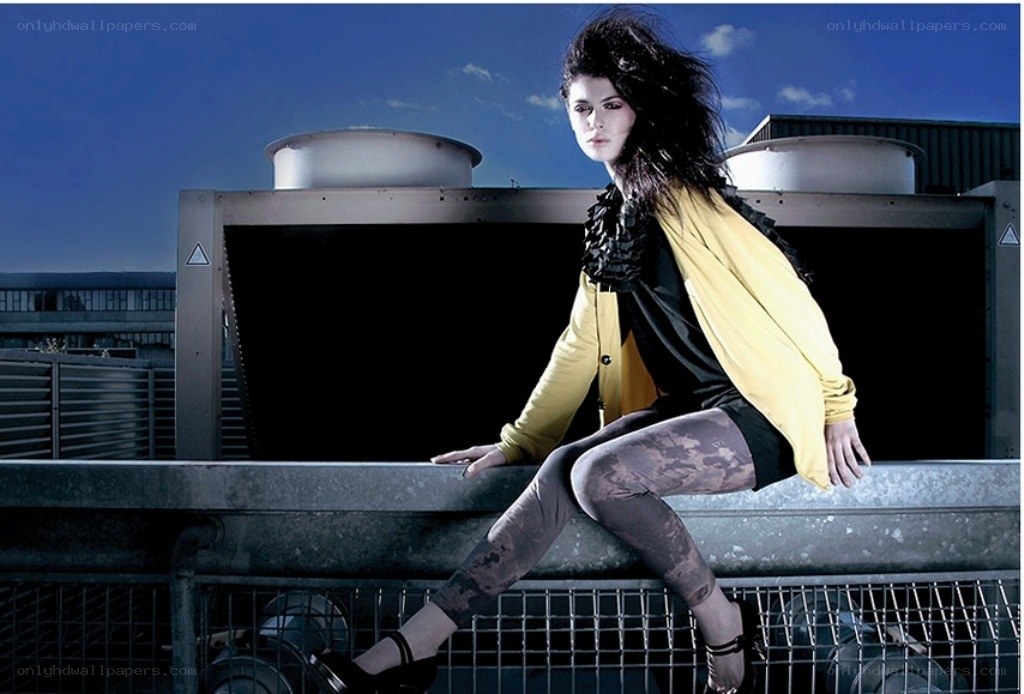 Woman in yellow jacket on rooftop
