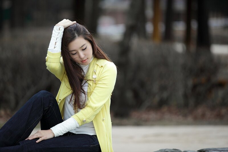 woman in yellow jacket sitting