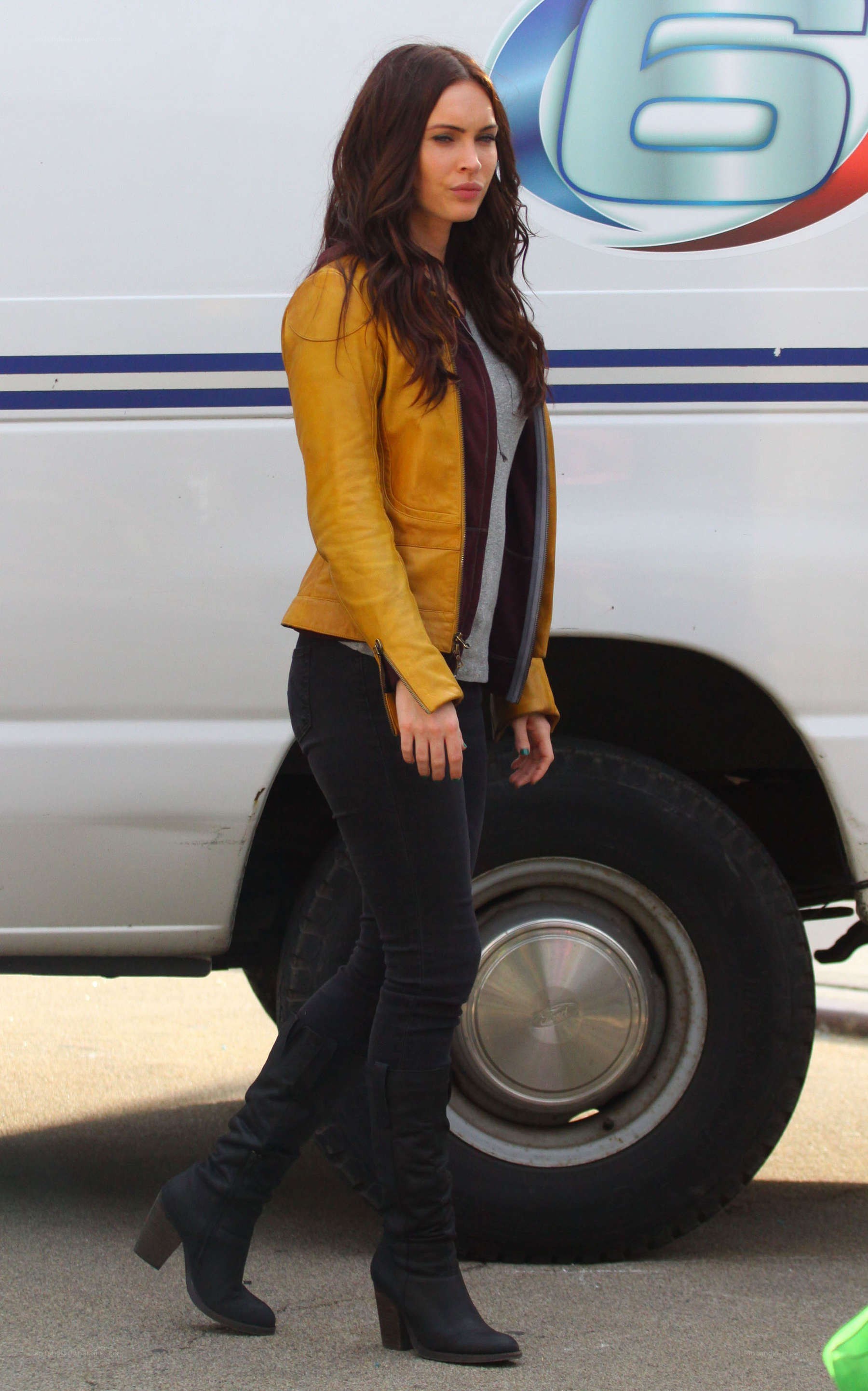 Woman in yellow jacket walking