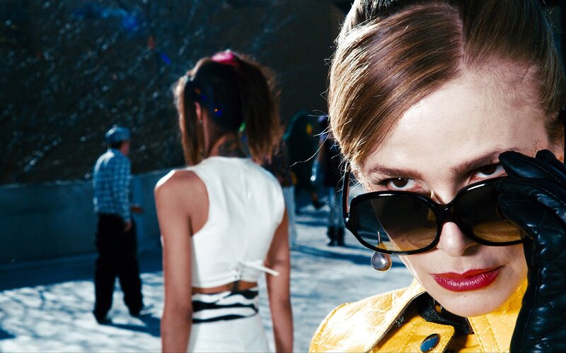 Woman in yellow jacket with sunglasses