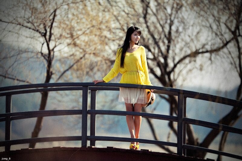 Woman in yellow on a bridge