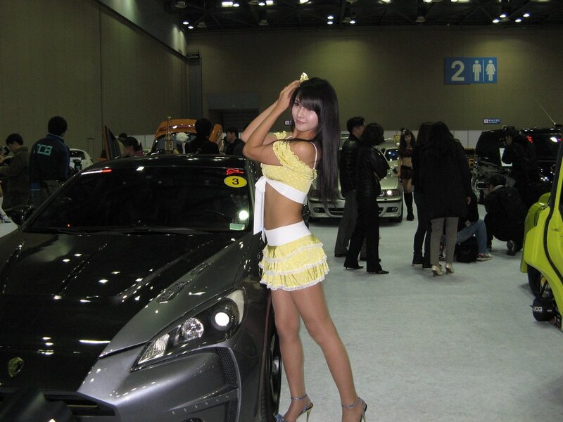 Woman in Yellow Outfit — Neutral, Photograph, Car