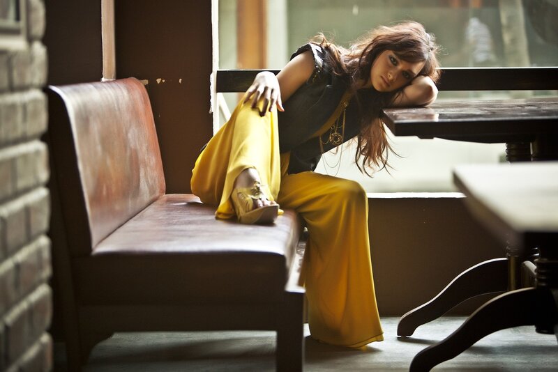 woman in yellow pants sitting