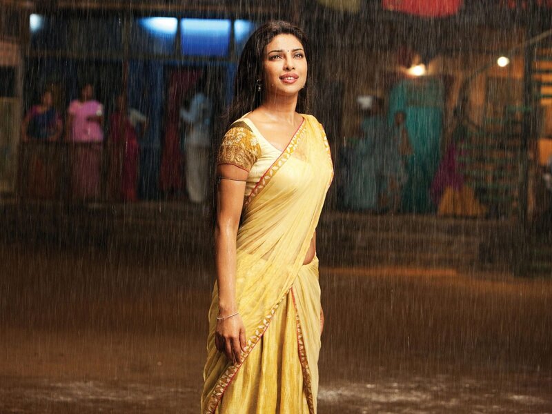 woman in yellow sari in rain
