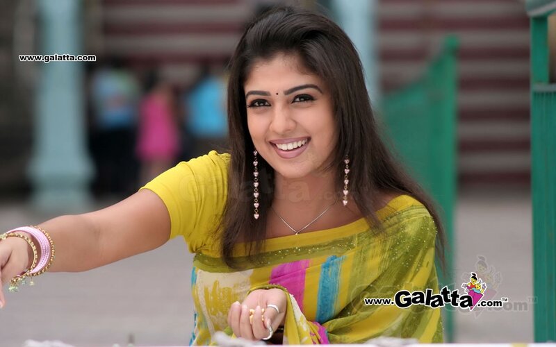 woman in yellow sari smiling