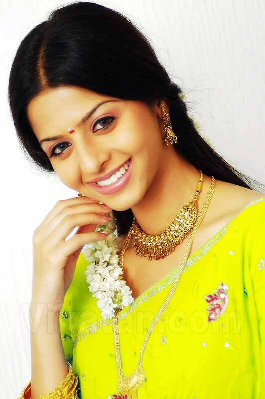 woman in yellow sari smiling