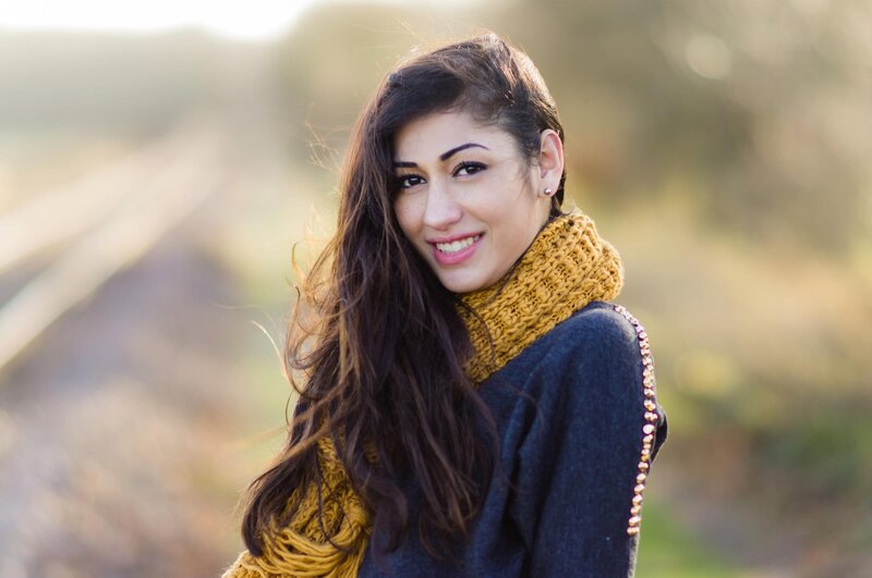 woman in yellow scarf smiling