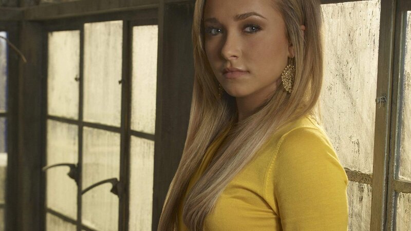 woman in yellow shirt by window