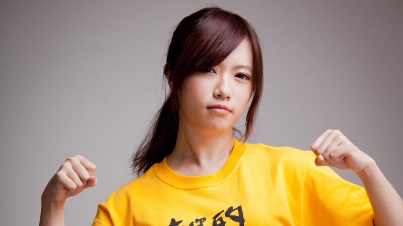 woman in yellow shirt flexing