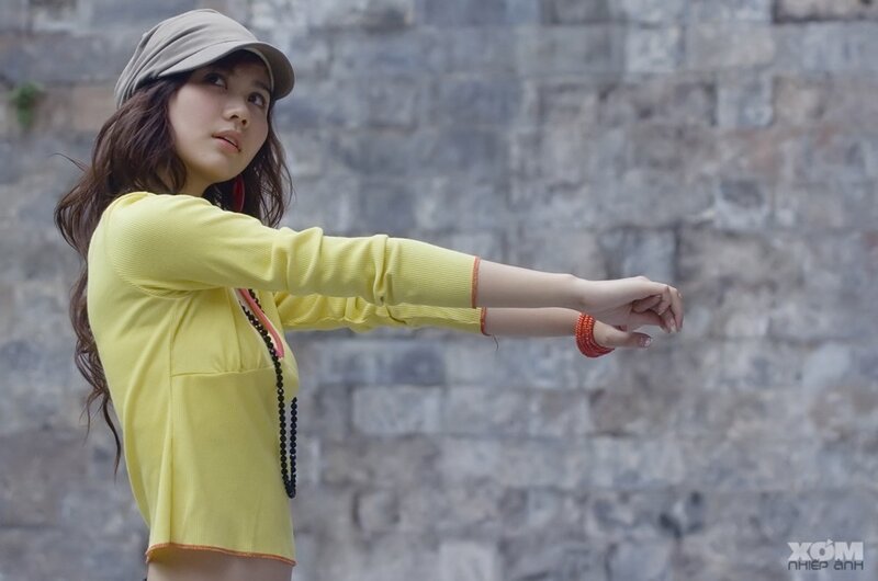 woman in yellow shirt posing