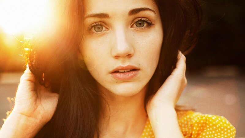 woman in yellow shirt with sun flare