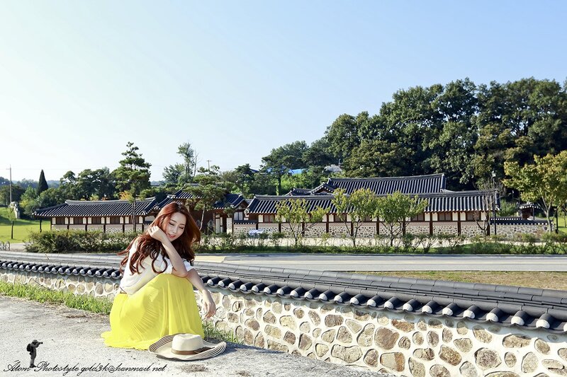Woman in yellow skirt at traditional Korean village