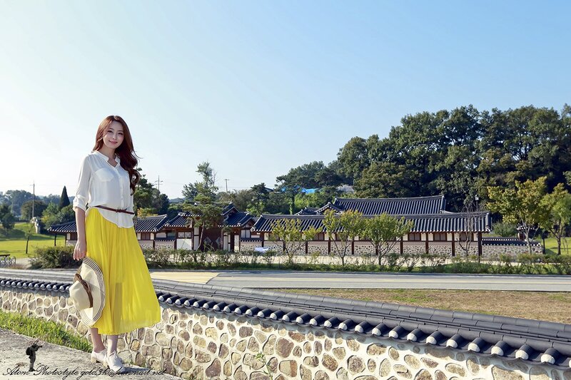 Woman in yellow skirt at traditional site