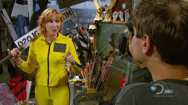 woman in yellow suit holding sword