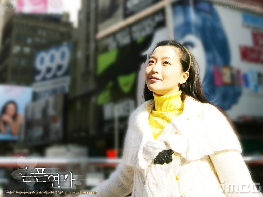 woman in yellow sweater in city