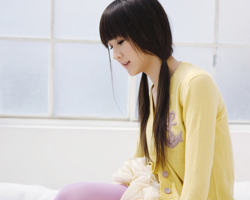 woman in yellow sweater sitting