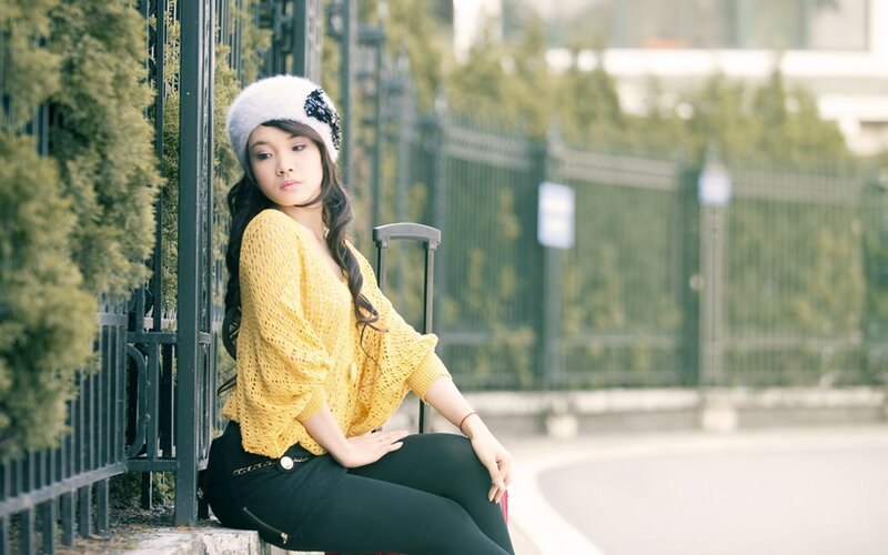 woman in yellow sweater sitting