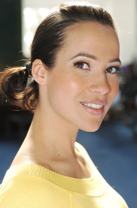 woman in yellow sweater smiling