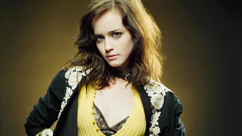woman in yellow top and black jacket