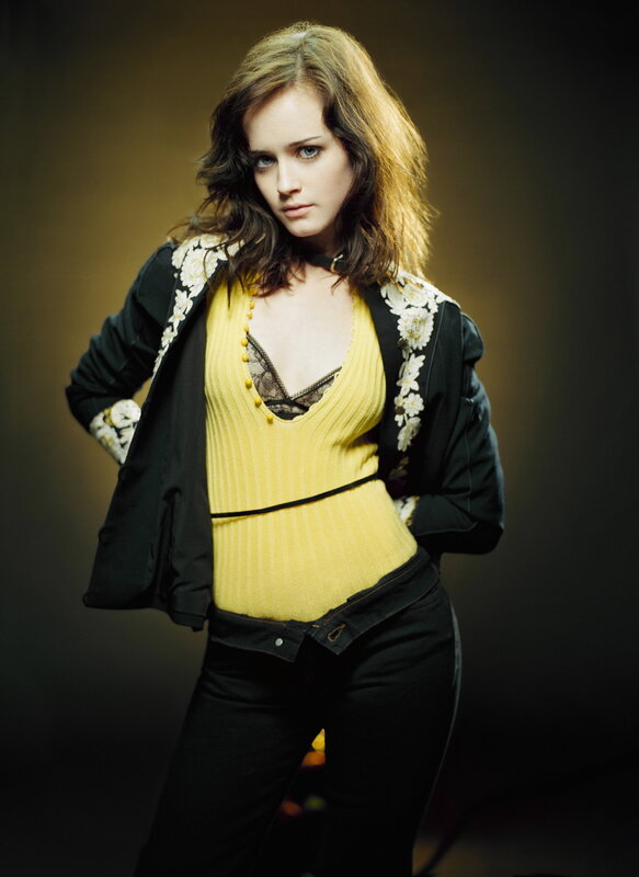 woman in yellow top and black jacket
