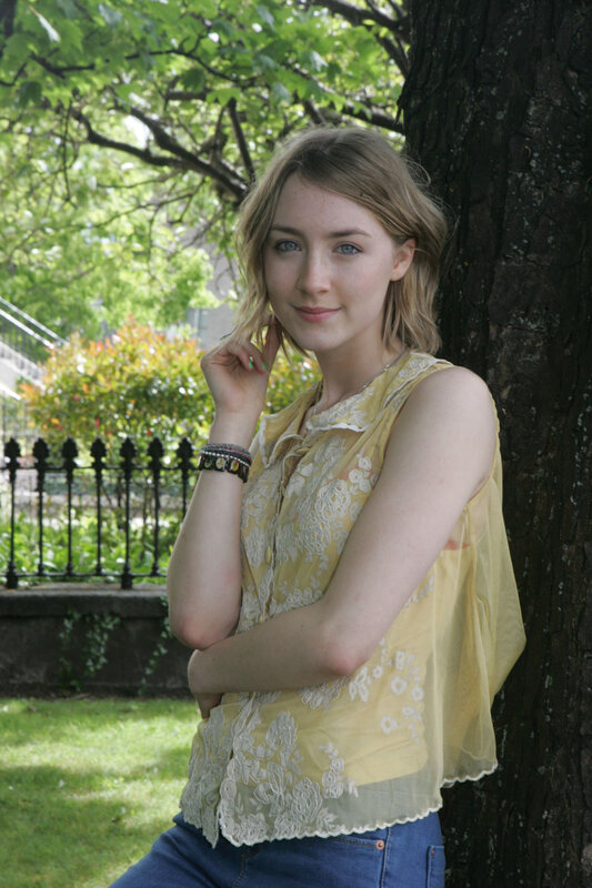 woman in yellow top by tree