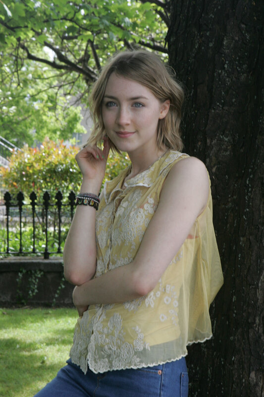 woman in yellow top by tree