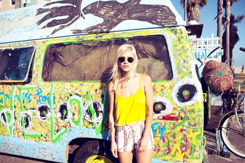 woman in yellow top by van