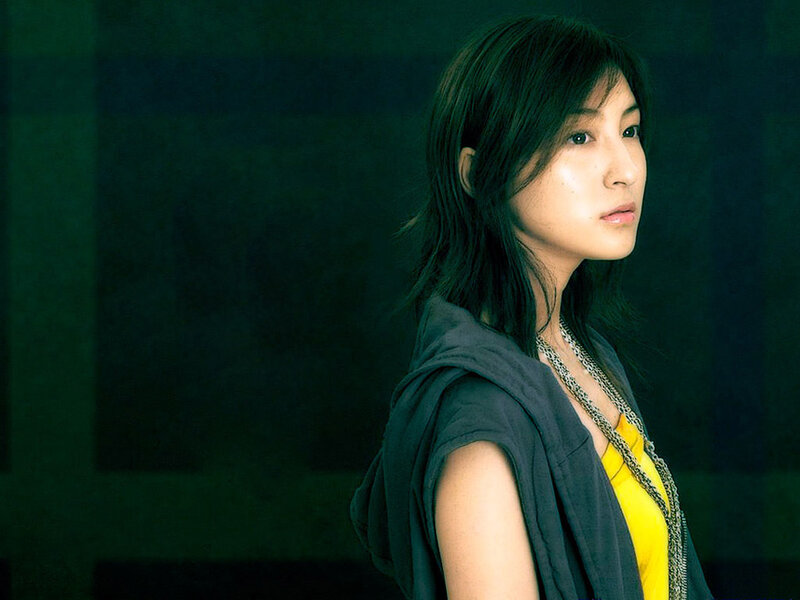 woman in yellow top looking away
