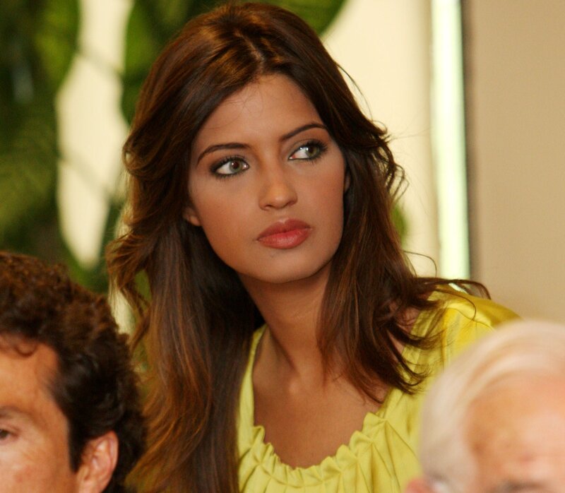 woman in yellow top looking away