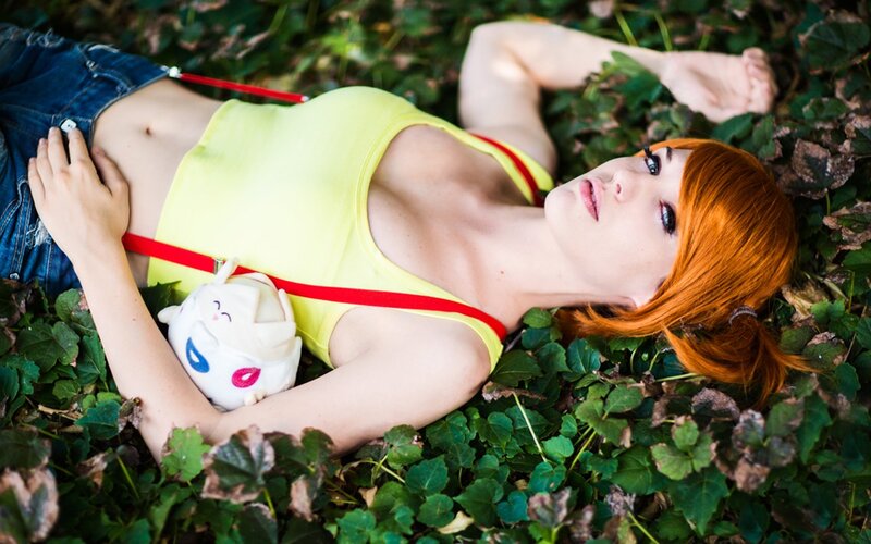 Woman in yellow top lying on leaves