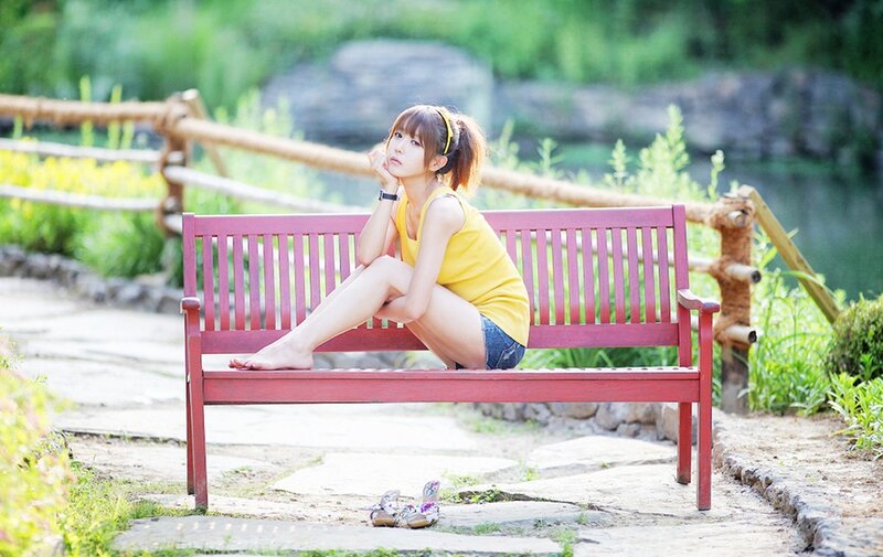 Woman in yellow top on bench