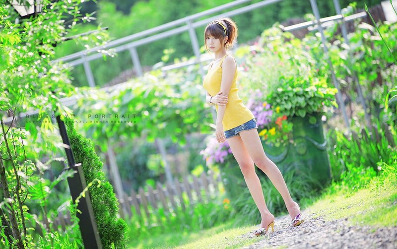 Woman in yellow top outdoors