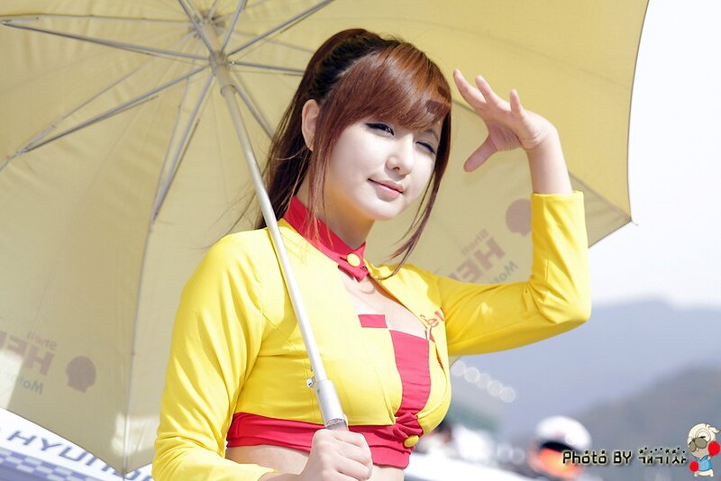 Woman in yellow uniform with umbrella