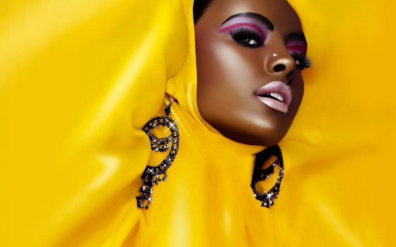 woman in yellow with bold makeup