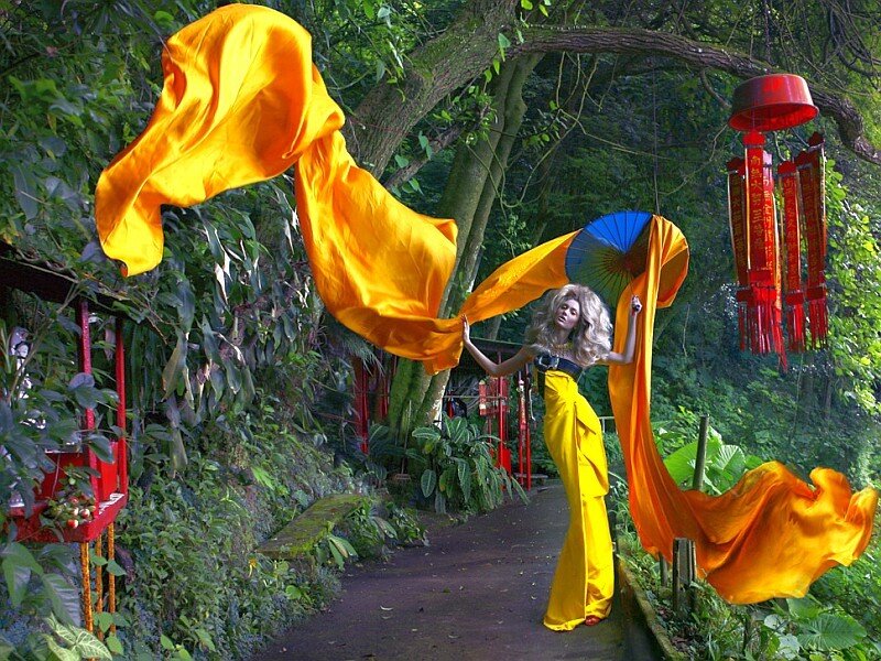 Woman in yellow with flowing fabric