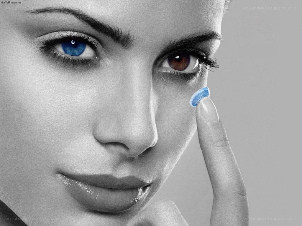 woman inserting contact lens