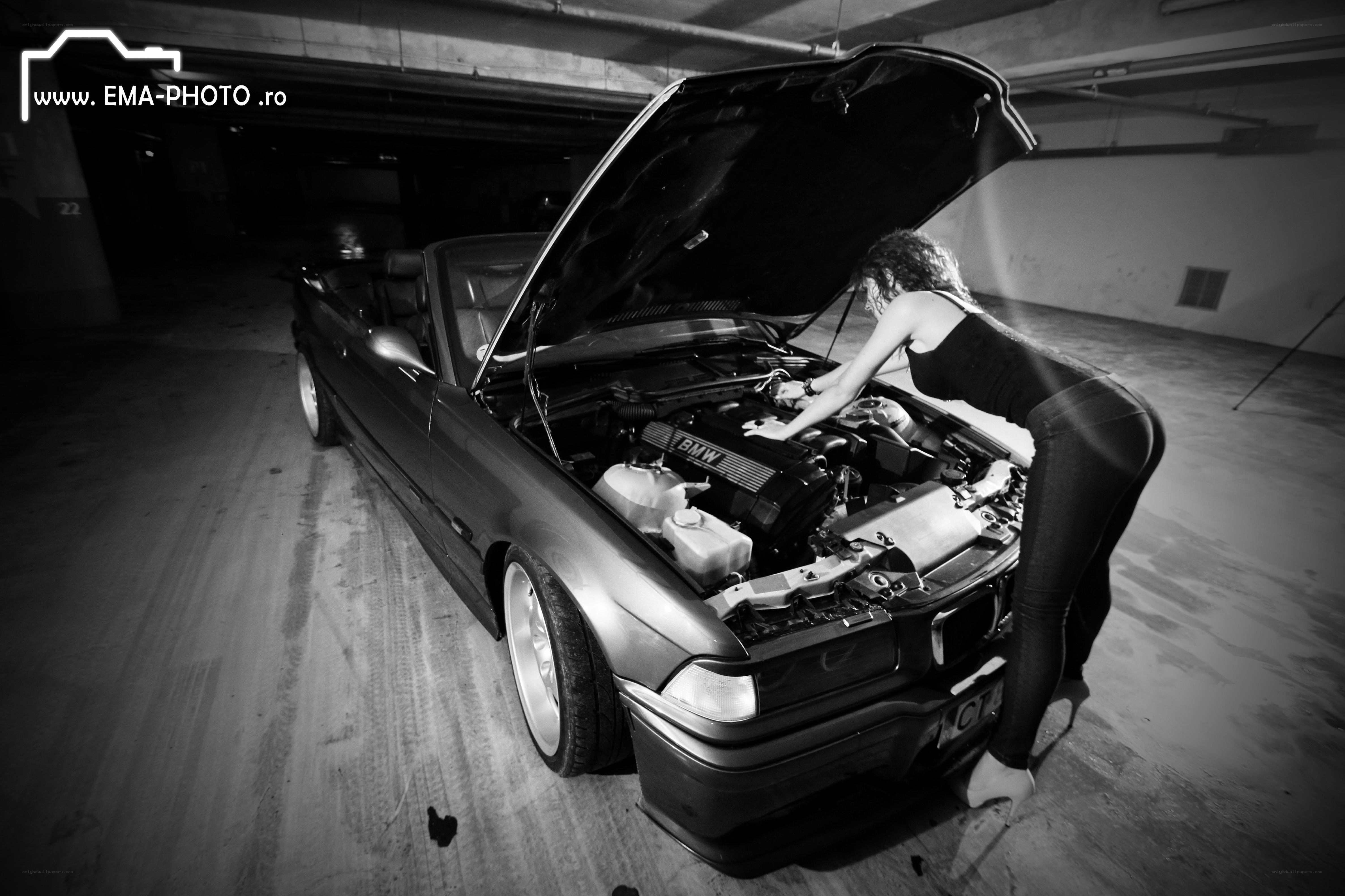 Woman inspecting car engine
