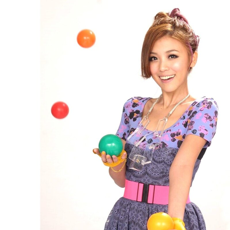 woman juggling colorful balls