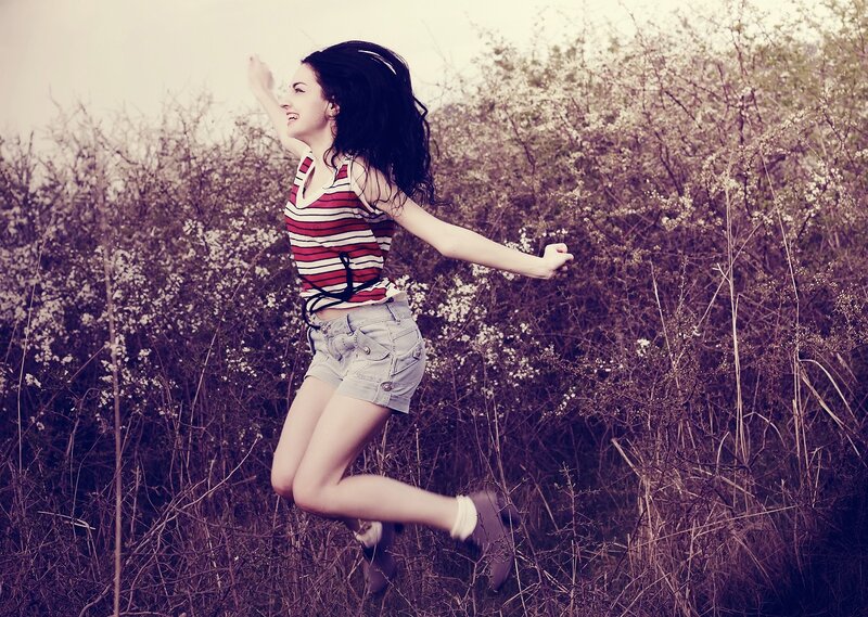 woman jumping in a field