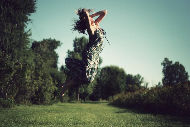 woman jumping in a field