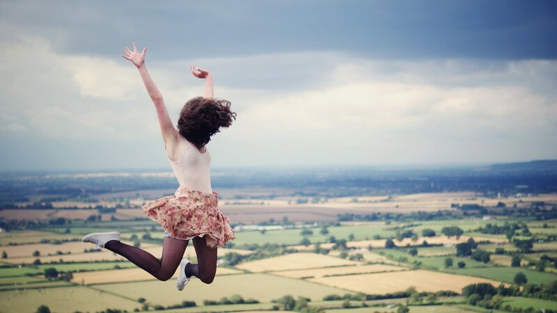 woman jumping in a field