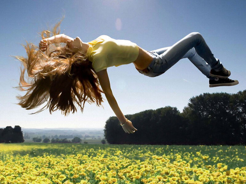 Woman jumping in a flower field
