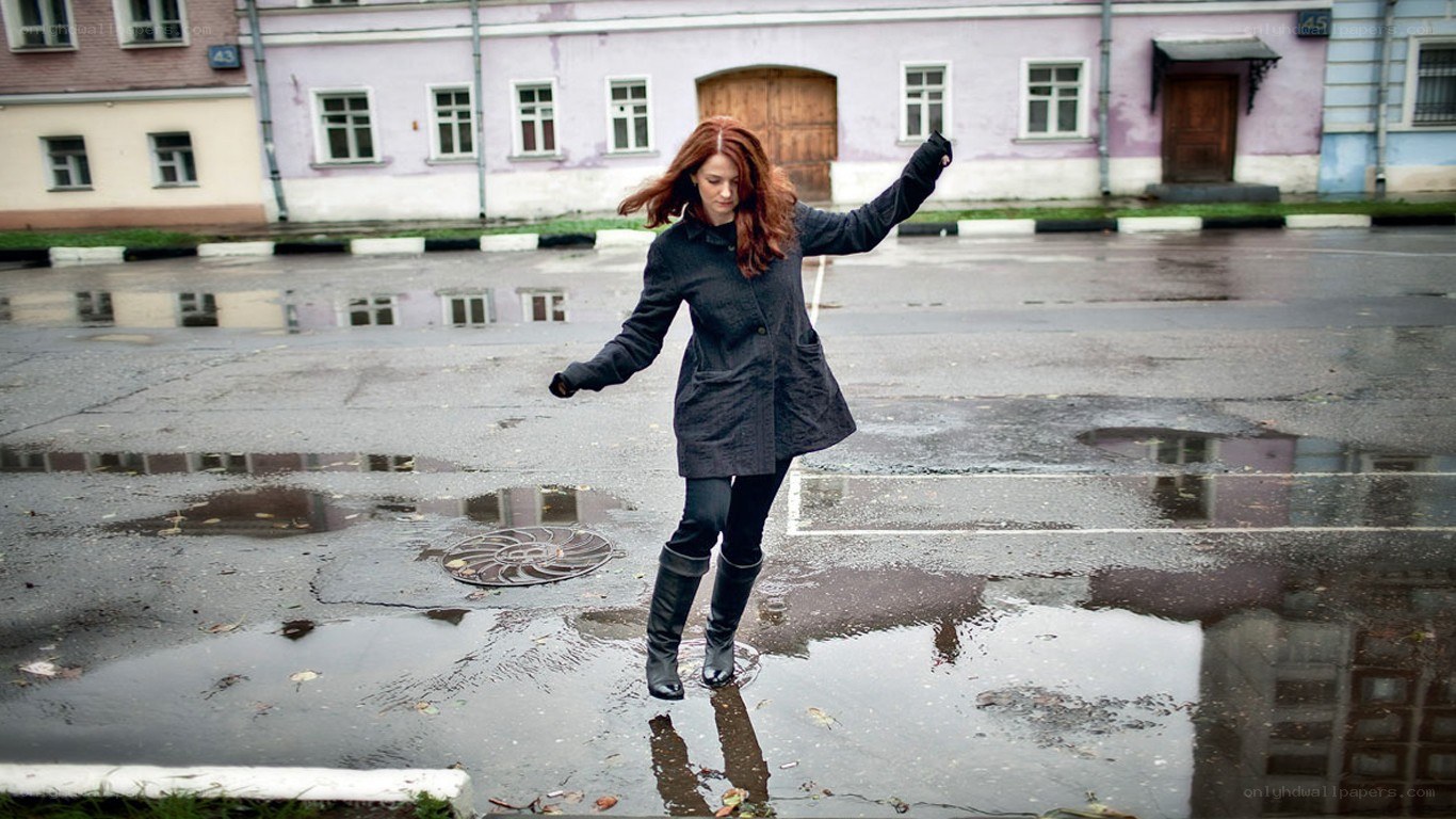 Woman jumping in a puddle