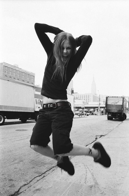 woman jumping in city street