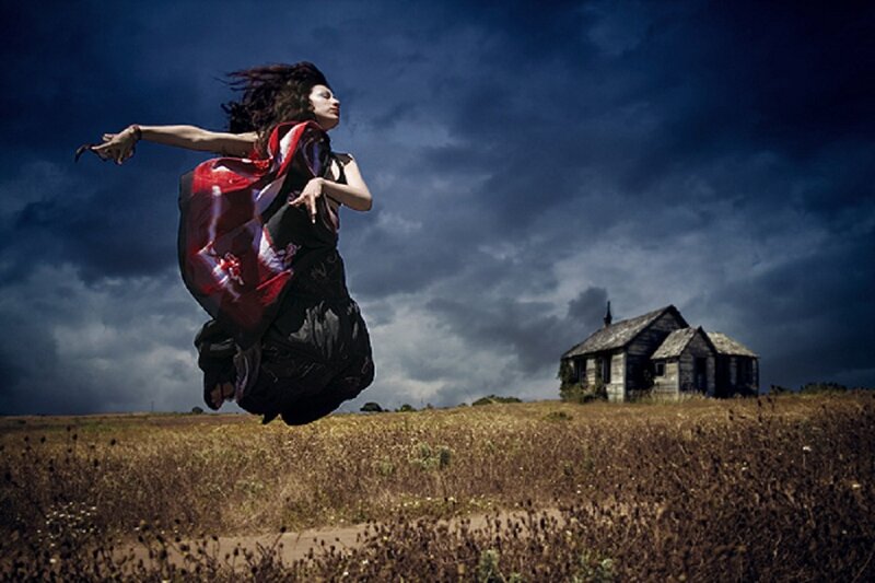 Woman Jumping in Field — Blue, Dramatic