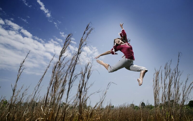 Woman Jumping in Field — Blue, Energetic