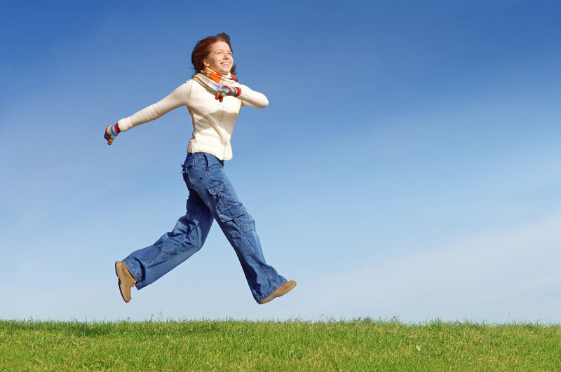 Woman Jumping in Field — Blue, Joyful, Afternoon, Photograph